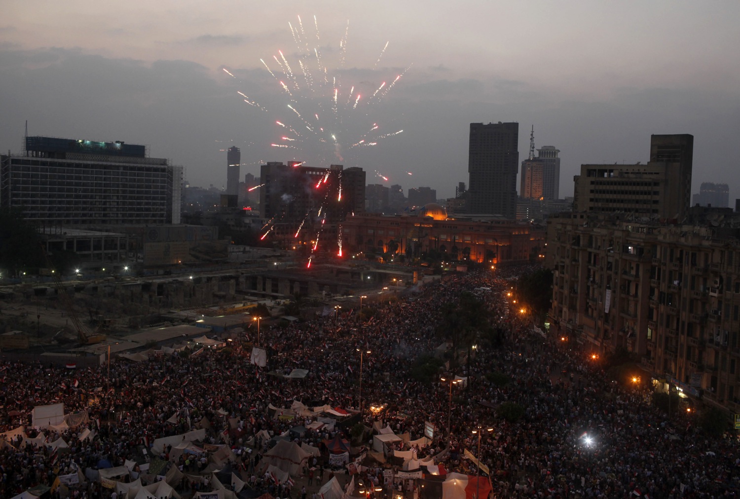Fireworks go off as protesters, who are against Egyptian President Mohamed Mursi, gather in Tahrir Square in Cairo
