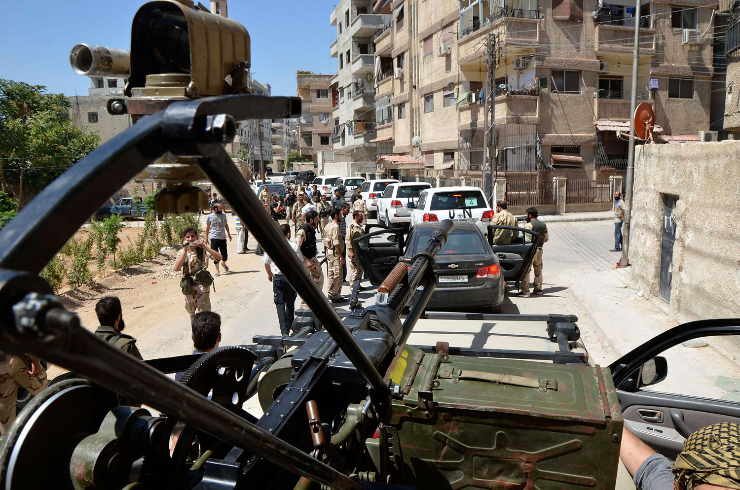 Free Syrian Army fighters escort a convoy of U.N. vehicles carrying a team of United Nations chemical weapons experts during their visit to one of the sites of an alleged chemical weapons attack in Damascus' suburbs of Zamalka, August 28, 2013