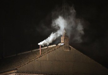 White smoke emits from the chimney on the Sistine Chapel as a new Pope is elected on March 13, 2013 in Vatican City, Vatican.
