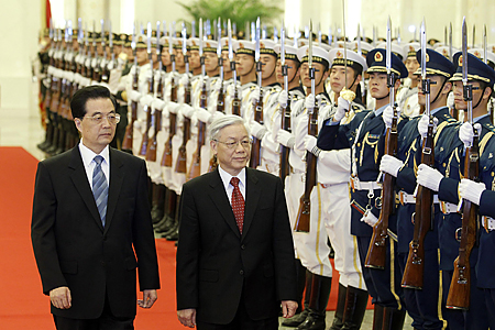 China's President Hu and Vietnam's Communist Party General Secretary Trong walk past guard of honour during welcoming ceremony at Great Hall of the People in Beijing