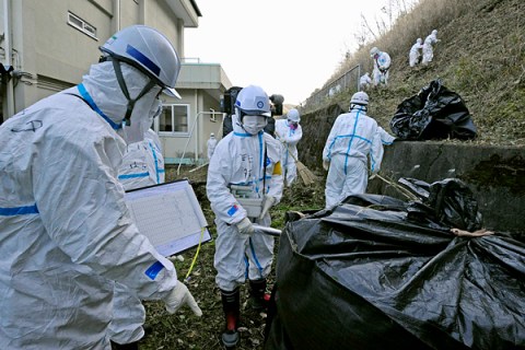 Workers decontaminate around an elementary school in the Katsurao town near the tsunami-crippled Fukushima Daiichi nuclear power plant in Fukushima
