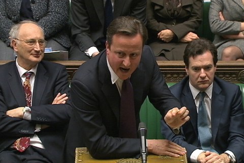 Britain's Prime Minister David Cameron is flanked by Chancellor of the Exchequer George Osborne and Leader of the House of Commons George Young during a parliamentary debate on last week's European Union summit, in London