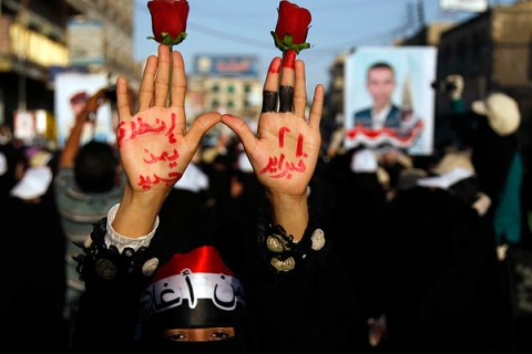 A woman displays a message written on her hands during a march to demand trial for Yemen's outgoing President Ali Abdullah Saleh in Sanaa