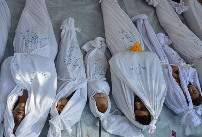 Bodies of people activists say were killed by nerve gas in the Ghouta region are seen in the Duma neighbourhood of Damascus