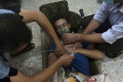 A man, affected by what activists say is nerve gas, breathes through an oxygen mask in the Damascus suburbs of Jesreen