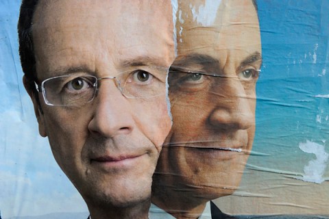 Official campaign posters for Sarkozy and Hollande for the French presidential election are displayed on a wall in Paris