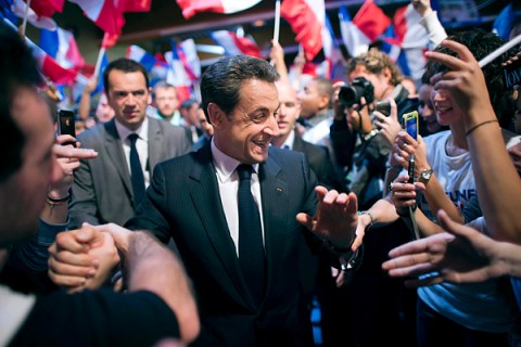 France's President and UMP party candidate for the French 2012 presidential election Sarkozy  shakes hands with supporters as he arrives at a campaign rally in Le Raincy