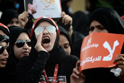 Bahraini protesters shout slogans as the