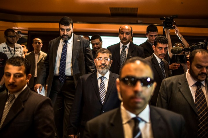 image: Egyptian presidential candidate Mohamed Morsi arrives to speak at a press conference on June 13, 2012 in Cairo.