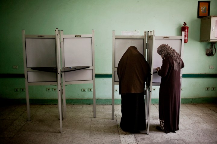 image: Egyptian women vote at a polling station in Shubrah El-Kheima, a working class, industrial area on the outskirts of Cairo, Egypt on June 16, 2012.