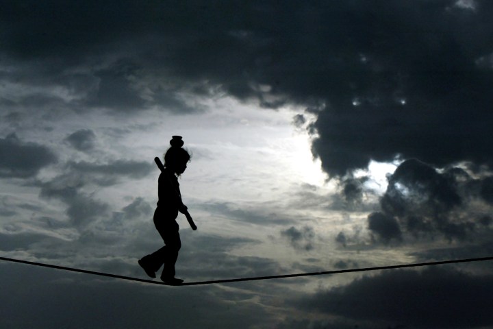 A young Indian girl walks a tightrope to