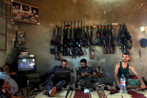 Free Syrian Army fighters sit in a house on the outskirts of Aleppo, Syria, Tuesday, June 12.
