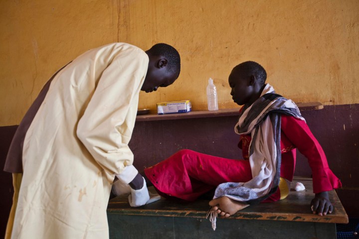 A girl is treated by a medic at the Aweil State Hospital in Aweil