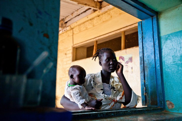 A woman and her child wait for test results at Aweil State Hospital in Aweil