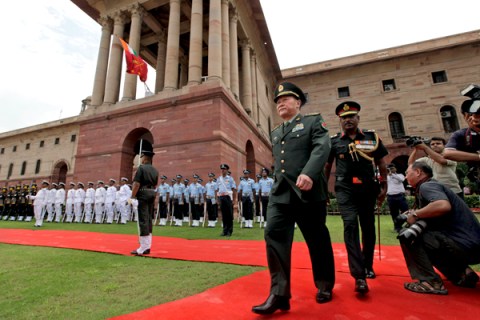 Chinese Defense Minister Liang Guanglie walks after inspecting a guard of honor in New Delhi.