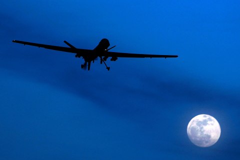 image: A U.S. Predator drone flies over the moon above Kandahar Air Field, southern Afghanistan, Jan. 31, 2010. 