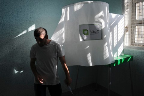 Inmate leaves voting booth during parliamentary election at polling station at Gldani prison No. 8 in Tbilisi