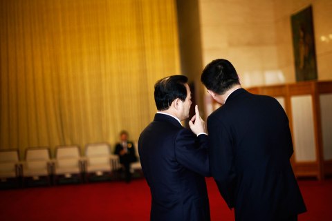 Delegates chat outside of the Guangxi room before a meeting