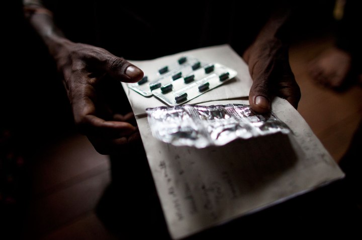 An HIV patient holds pills for his stomach ache and diarrhea at an HIV/AIDS center on the outskirts of Yangon, Myanmar. 