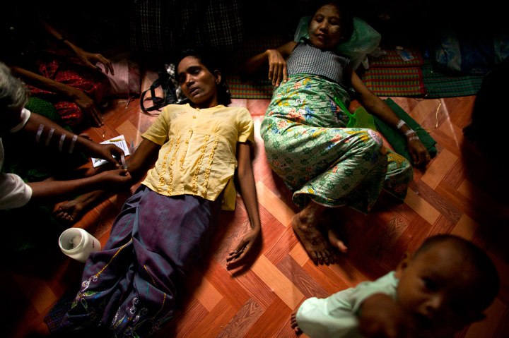 An HIV-infected woman, center left, gets her medicine through intravenous drips