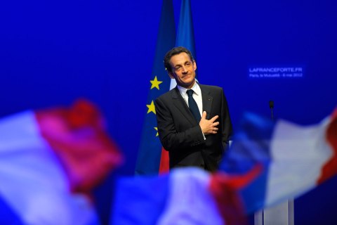 image: Former president Nicolas Sarkozy reacts after his defeat for re-election in the second round vote of the 2012 French presidential elections as he appears on stage before UMP party supporters at the Mutualite meeting hall in Paris, May 6, 2012.
