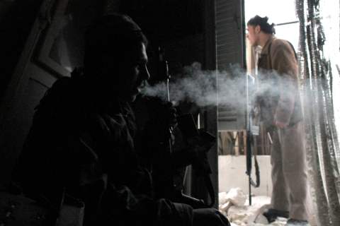A Free Syrian Army fighter smokes as he takes a break in Aleppo