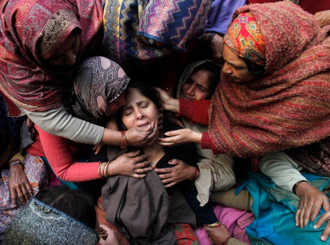 image: Relatives of Indian policeman Subash Tomar mourn during his funeral in New Delhi on Dec. 25, 2012.