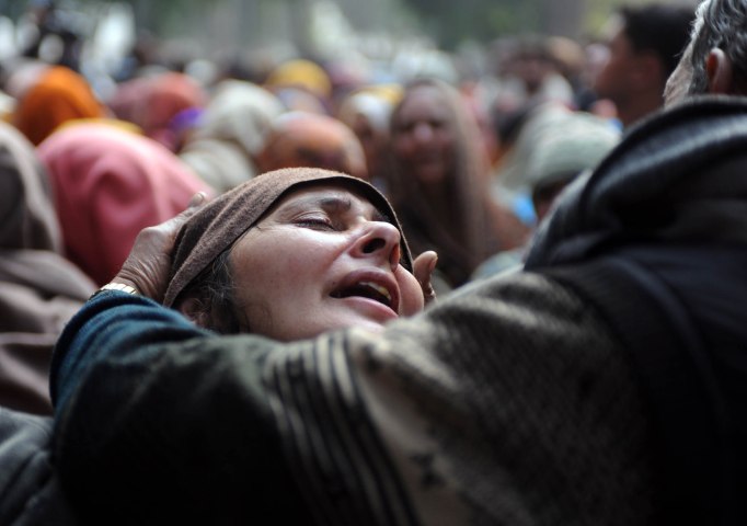 image: A relative of Indian policeman Subash Tomar mourns during his funeral in New Delhi on Dec. 25, 2012.