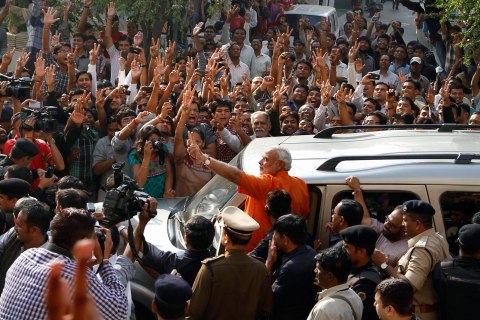 image: Indian state of Gujarat chief minister Narendra Modi greets his supporters after casting his vote in the second phase of Gujarat state assembly elections in Ahmadabad, India, Dec. 17, 2012