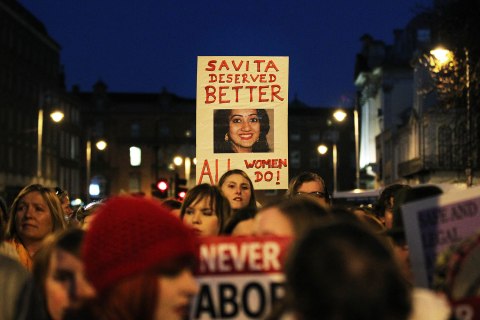 image: Demonstrators hold placards and candles in memory of Indian Savita Halappanavar during a march in support of legislative change on abortion in Dublin, Ireland, Nov. 17, 2012. 