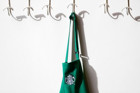 image: A barrista's apron hangs on a peg in Starbucks' Mayfair Vigo Street branch in central London, Sept. 12, 2012.