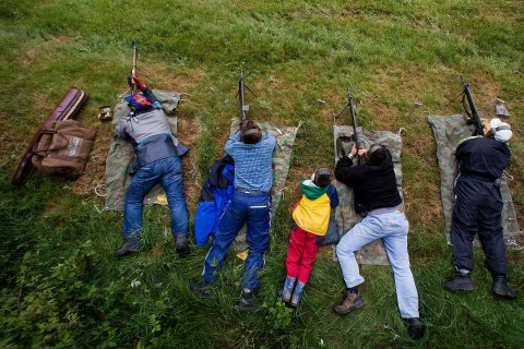 image: Swiss marksmen shoot with their rifles at targets over 300 metres away in a field during the 'Eidgenoessisches Feldschiessen' (annual shooting skills exercise) on the Aeschlenalp near Bern, June 6, 2009. 