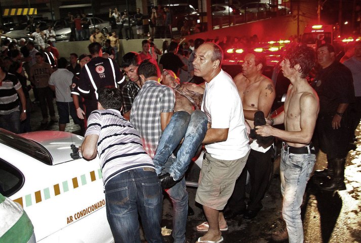 Locals help evacuate injured people after a fire at Boate Kiss nightclub in Santa Maria,, Brazil, Jan. 27, 2013. 