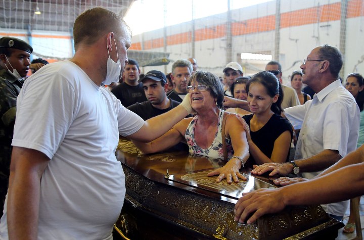Relatives of victims from a fire that broke out at Kiss nightclub weep during their funeral in Santa Maria, Brazil, Jan. 27, 2013.