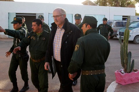 Algerian Gendarmes escort a freed Norwegian hostage Oddvar Birkedal at a police station in In Amenas. 