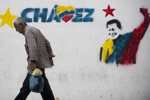 image: A man walks past a mural of Venezuelan President Hugo Chavez in Caracas, Jan. 11, 2013. 