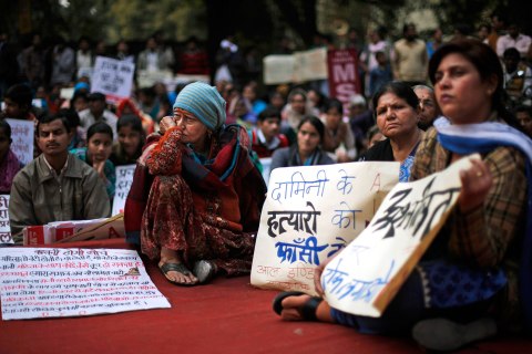Indians listen to a speaker during a protest against the alleged inaction by the Indian government in the case of the gang rape of a 23-years old student in a bus a month ago in New Delhi, Jan. 16, 2013.