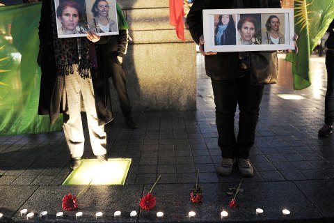 image: People of Kurdish origin hold photos of three Kurdish women activists, killed yesterday in Paris during a demonstration on in Strasbourg, France, Jan. 10, 2013.