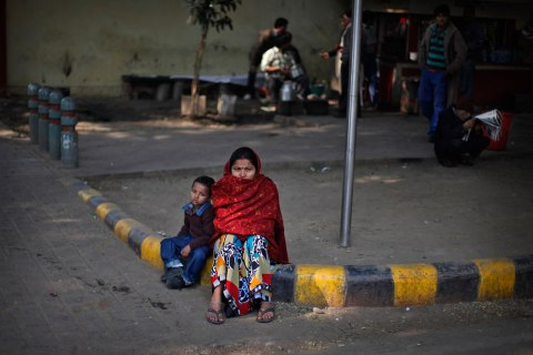 image: An Indian woman and her son watch a protest in New Delhi, Jan. 13, 2013. 