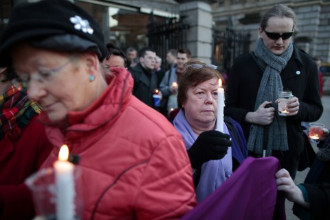 Relatives of victims of the Magdalene Laundries hold a candle lit vigil in solidarity with Justice for Magdalene Survivors