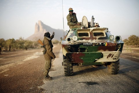 A convoy of Malian troops makes a stop to test some of their weapons near Hambori, northern Mali, on the road to Gao, Feb. 4, 2013.  