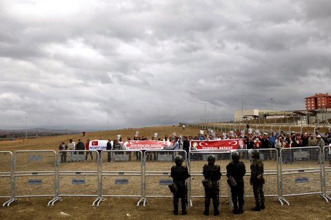 Protestors hold banners prior the Ergenekon trial in front of heavily guarded Silivri prison, Turkey, Sept. 7, 2009.