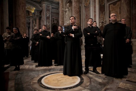Preists attend a Mass for the election of a new pope inside St. Peter's Basilica, at the Vatican.
