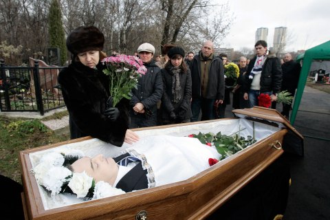 Nataliya Magnitskaya, mother of Sergei Magnitsky, grieves over her son 's body during his funeral at a cemetery in Moscow