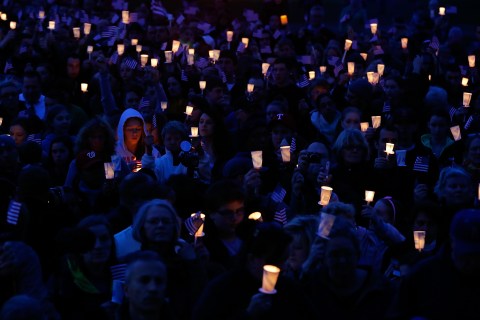People gather with candles during a vigil for eight-year-old Martin Richard, from Dorchester, who was killed by an explosion near the finish line of the Boston Marathon on April 16, 2013 at Garvey Park in Boston, Mass.