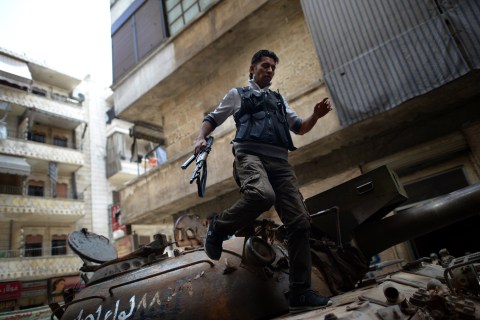 A Syrian rebel patrols an area in the Sheikh Maqsud district of the northern Syrian city of Aleppo, on April 11, 2013.