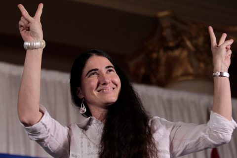 Yoani Sanchez, the best-known dissident blogger from Cuba, reacts to applause before speaking at the Freedom Tower in Miami