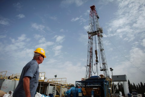 A worker walks near an oil rig belonging to Zion Oil and Gas in Karkur, in northern Israel, on Oct. 17, 2010.