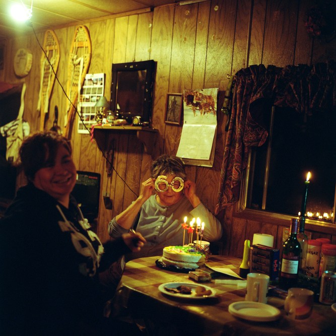 Dora L'Hommecourt celebrates her 60th birthday at Poplar Point Reserve. Polar Point is a historic meeting place for First Nations along the Athabasca River between Fort McKay and Fort Chipewyan. It no longer has any permanent residents, but offers a getaway from the industrial landscape now surrounding Fort McKay. Dora who has worked for the oil companies much of her life now works as the custodian for the Band Hall. She hopes to retire here in Poplar Point, where her parents are buried, but fears that the Oil companies will move into the area.