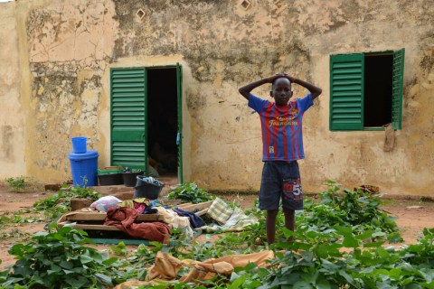 A young boy whose family was displaced by the floods stands at a school in Niamey, Niger, Aug. 21, 2012.